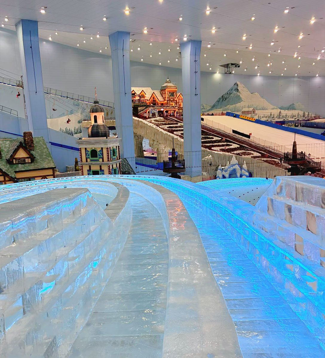 Transparent ice slide made from crystal-clear block ice for ice parks, winter attractions, and themed entertainment venues.