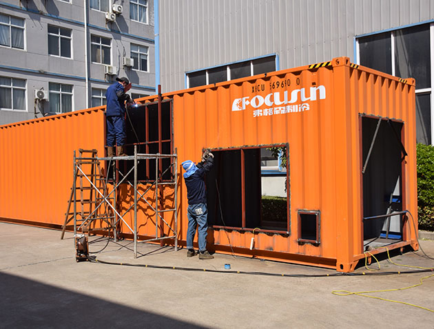 Containerized snow making machine with integrated snowmaking equipment for efficient artificial snow production in ski resorts and snow parks.